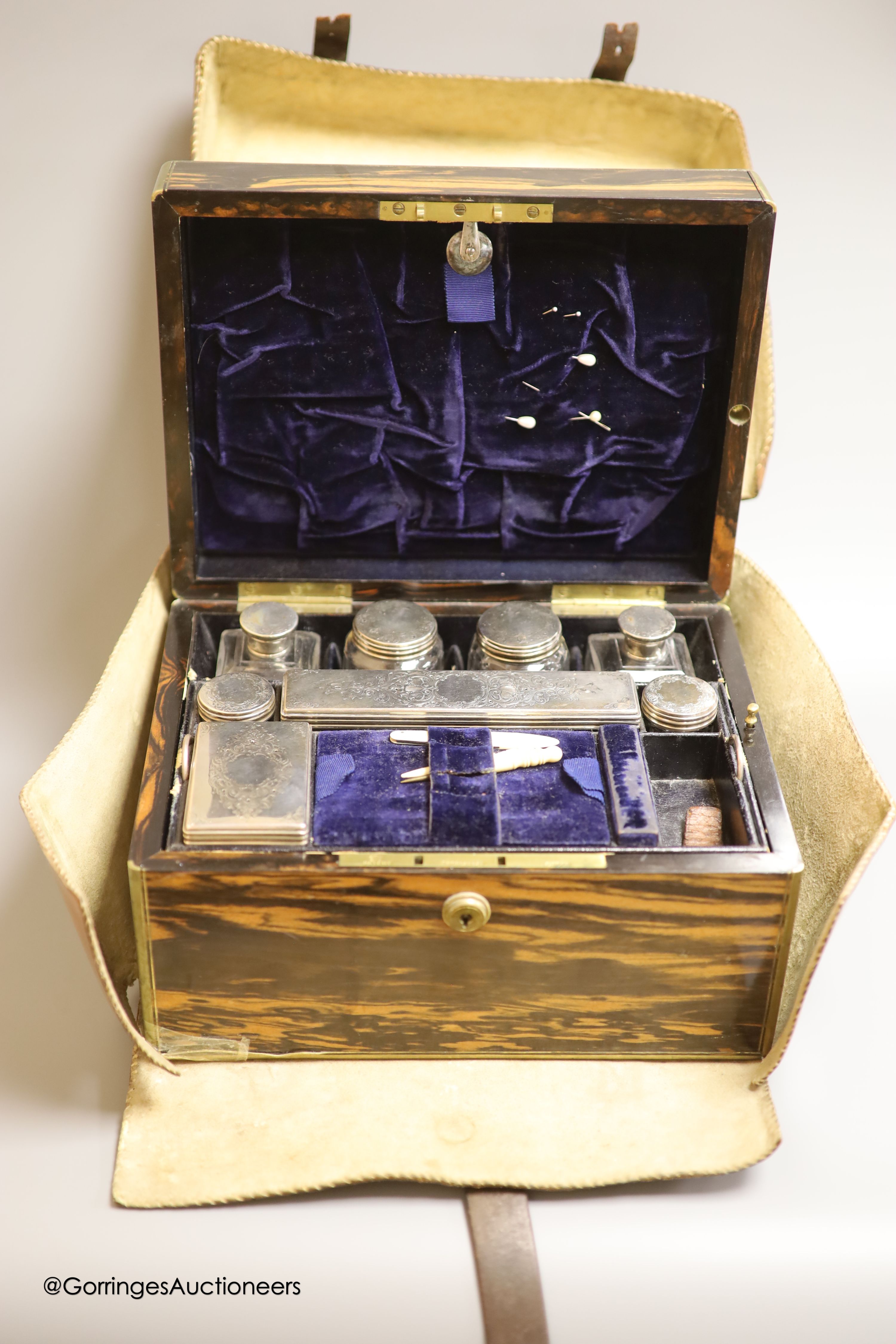 A Victorian brass mounted coromandel travelling toilet box, by S. Mordan & Co, containing eight (ex 9) silver mounted glass toilet jars, James Vickery, London, 1855, box, 28cm.